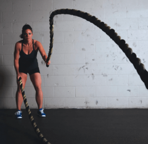 woman using battle ropes